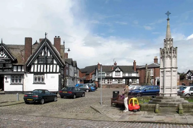 Sandbach Cobbles with Half-timbered Pubs ,including the the Black bear to the left , the War Memorial and the Saxon crosses in the background, Sandbach, in Cheshire, England.